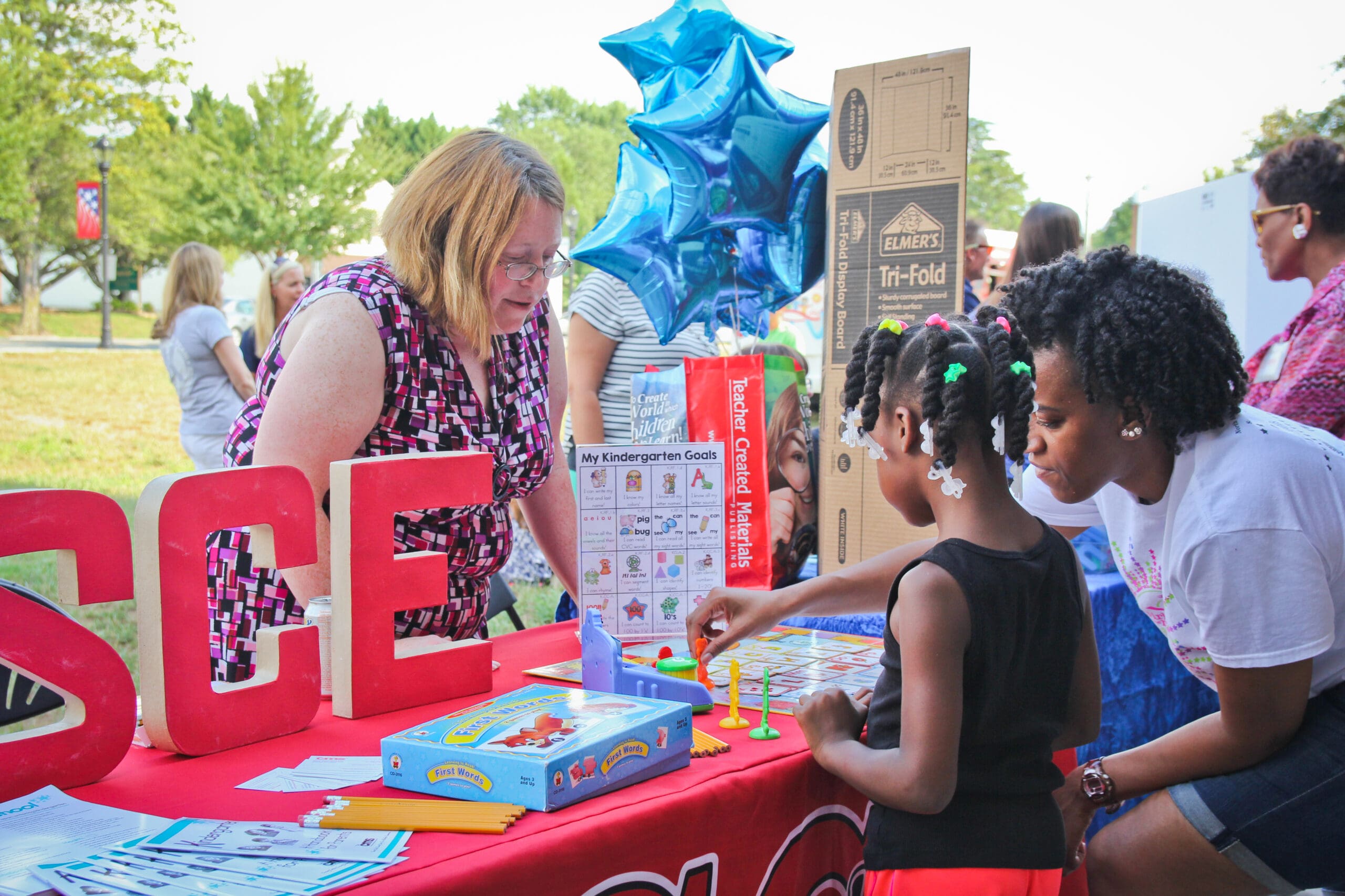 A young family with a community partner at the annual Countdown to Kindergarten.